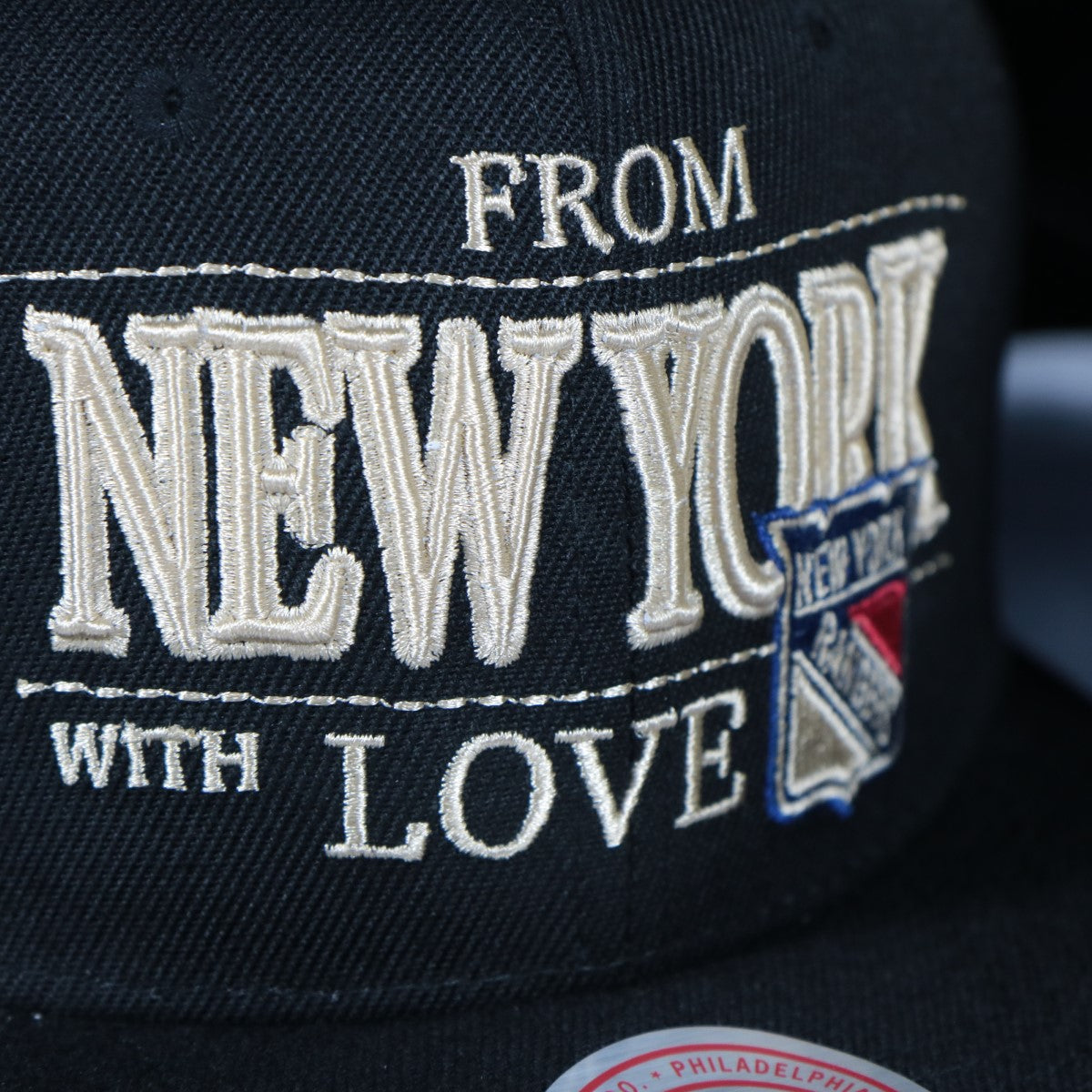 rangers logo on the New York Rangers With Love 75th Anniversary Side Patch Cream Bottom | Black Snapback Hat