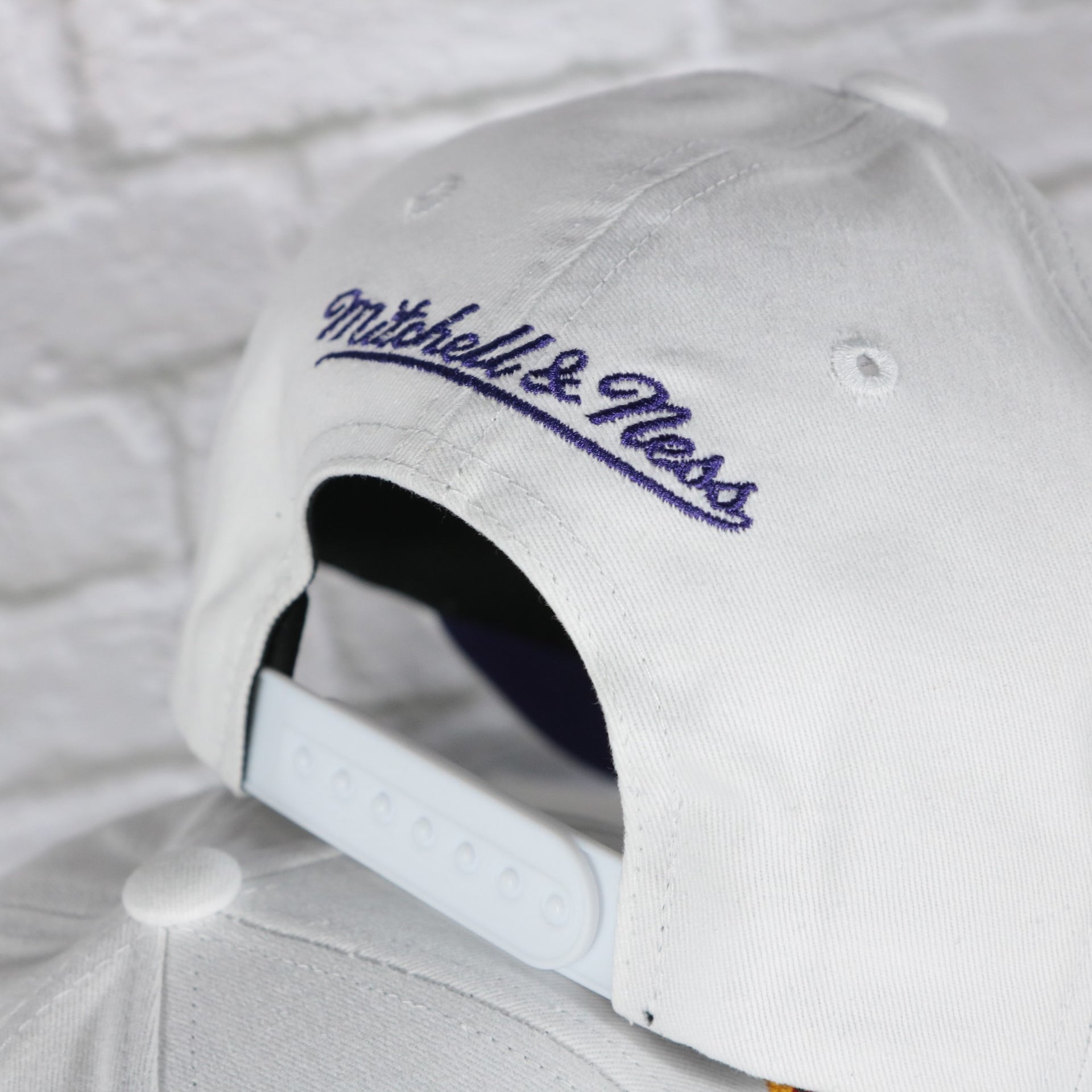 mitchell and ness logo on the Phoenix Suns NBA Hardwood Classics All in Pro Purple Bottom | White Snapback Hat