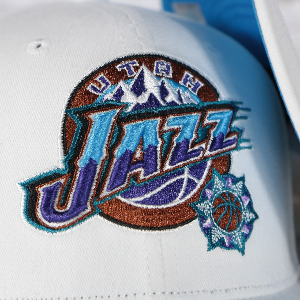 jazz logo on the Utah Jazz NBA Hardwood Classics All in Pro Blue Bottom | White Snapback Hat