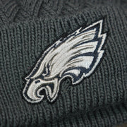 The Eagles Logo on the Women's Philadelphia Eagles On Field NFL Crucial Catch Intercept Cancer Patch Rainbow Pom Pom Winter Beanie | Graphite Gray Winter Beanie