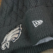 The New Era Logo on the Women's Philadelphia Eagles On Field NFL Crucial Catch Intercept Cancer Patch Rainbow Pom Pom Winter Beanie | Graphite Gray Winter Beanie