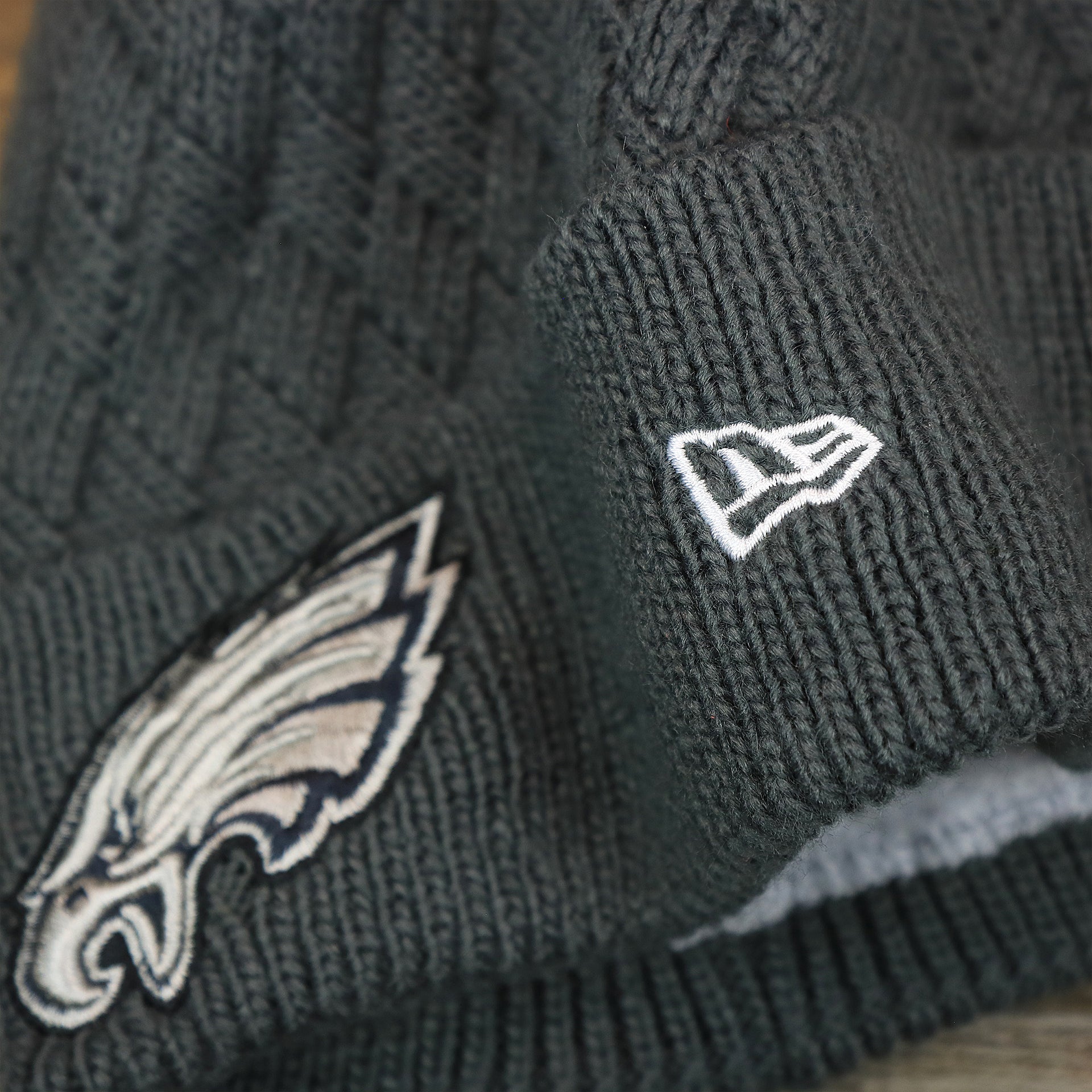 The New Era Logo on the Women's Philadelphia Eagles On Field NFL Crucial Catch Intercept Cancer Patch Rainbow Pom Pom Winter Beanie | Graphite Gray Winter Beanie