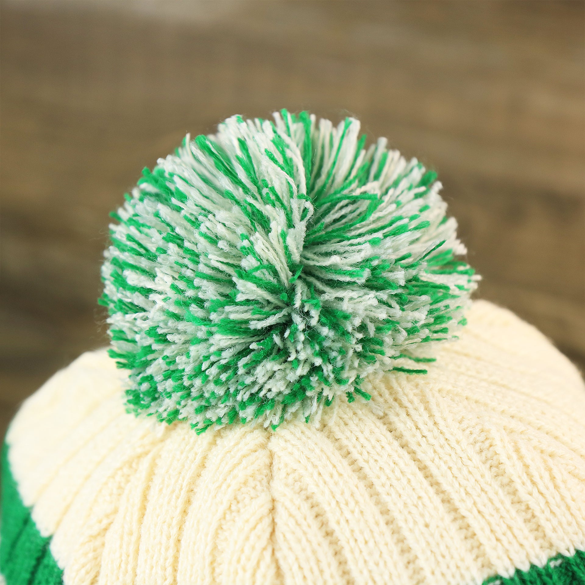 The Green And White Pom Pom on the Throwback Philadelphia Eagles Legacy 1987 Eagles Patch Pom Pom Beanie | Natural Beanie