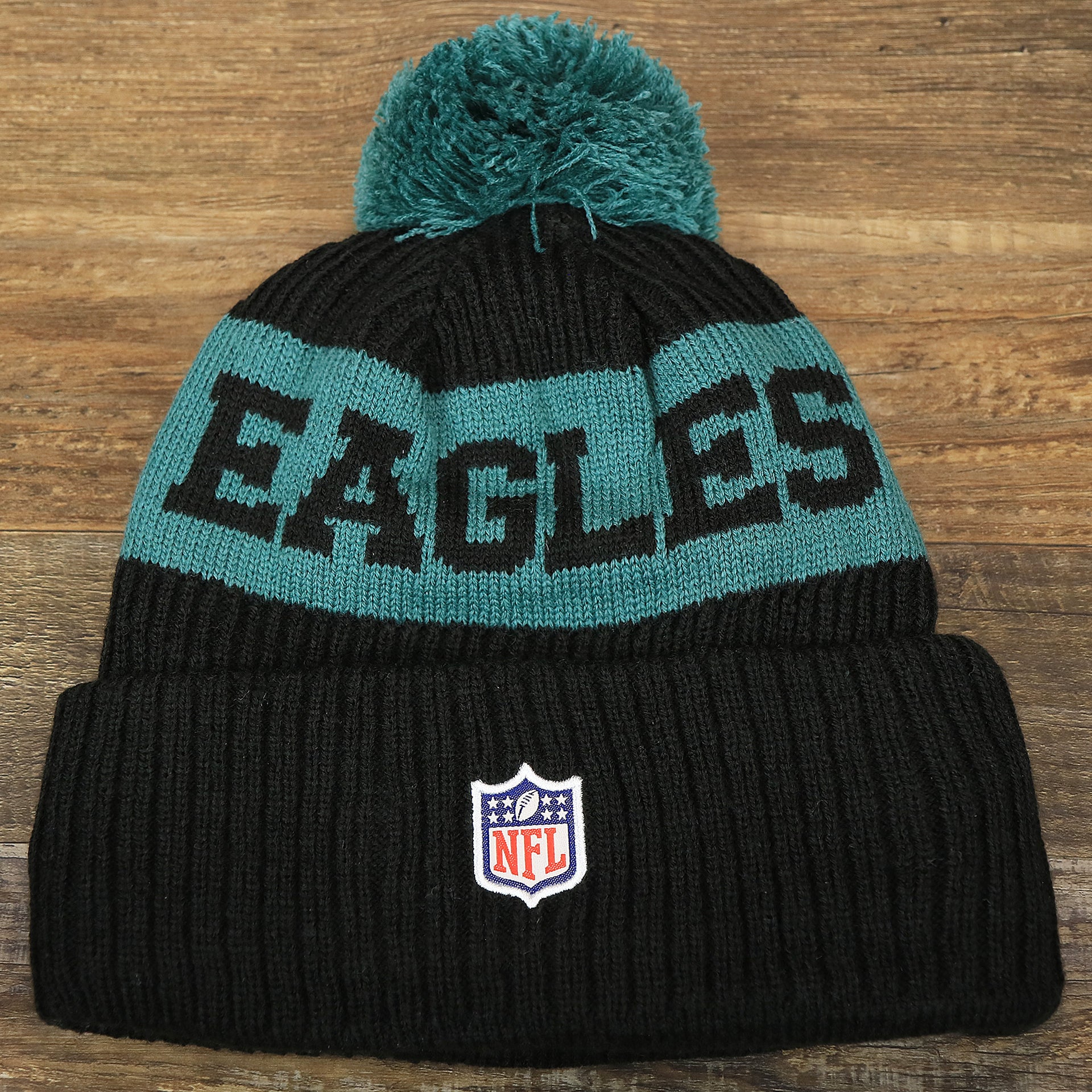 The backside of the Philadelphia Eagles Sideline On Field Pom Pom Winter Beanie | Black Winter Beanie