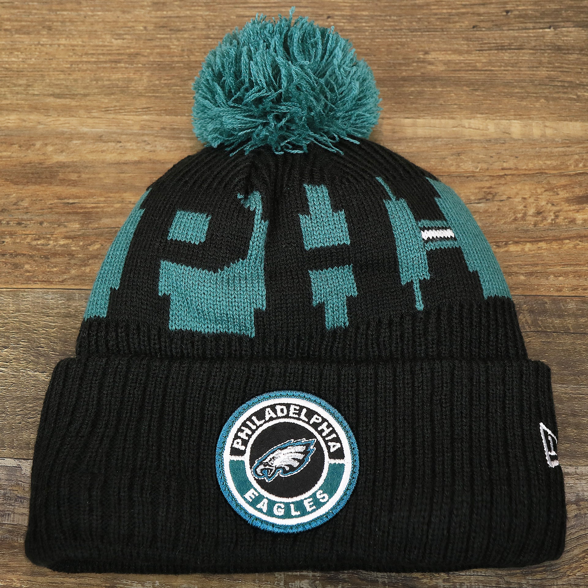 The front of the Philadelphia Eagles Sideline On Field Pom Pom Winter Beanie | Black Winter Beanie