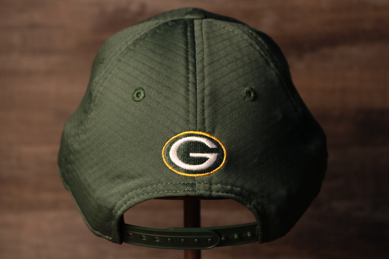 The backside of this cap has the packers logo above the adjustable snap Packers 2020 Training Camp Snapback Hat | Green Bay Packers 2020 On-Field Green Training Camp Snap Cap