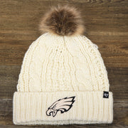 The front of the Women’s Philadelphia Eagles Cuffed Winter Knit Beanie With Meeko Pom Pom | Women’s Cream Winter Beanie