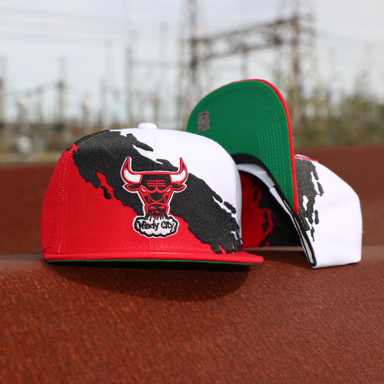 front and bottom of the Chicago Bulls Vintage Retro NBA Paintbrush Mitchell and Ness Snapback Hat | Red/White/Black