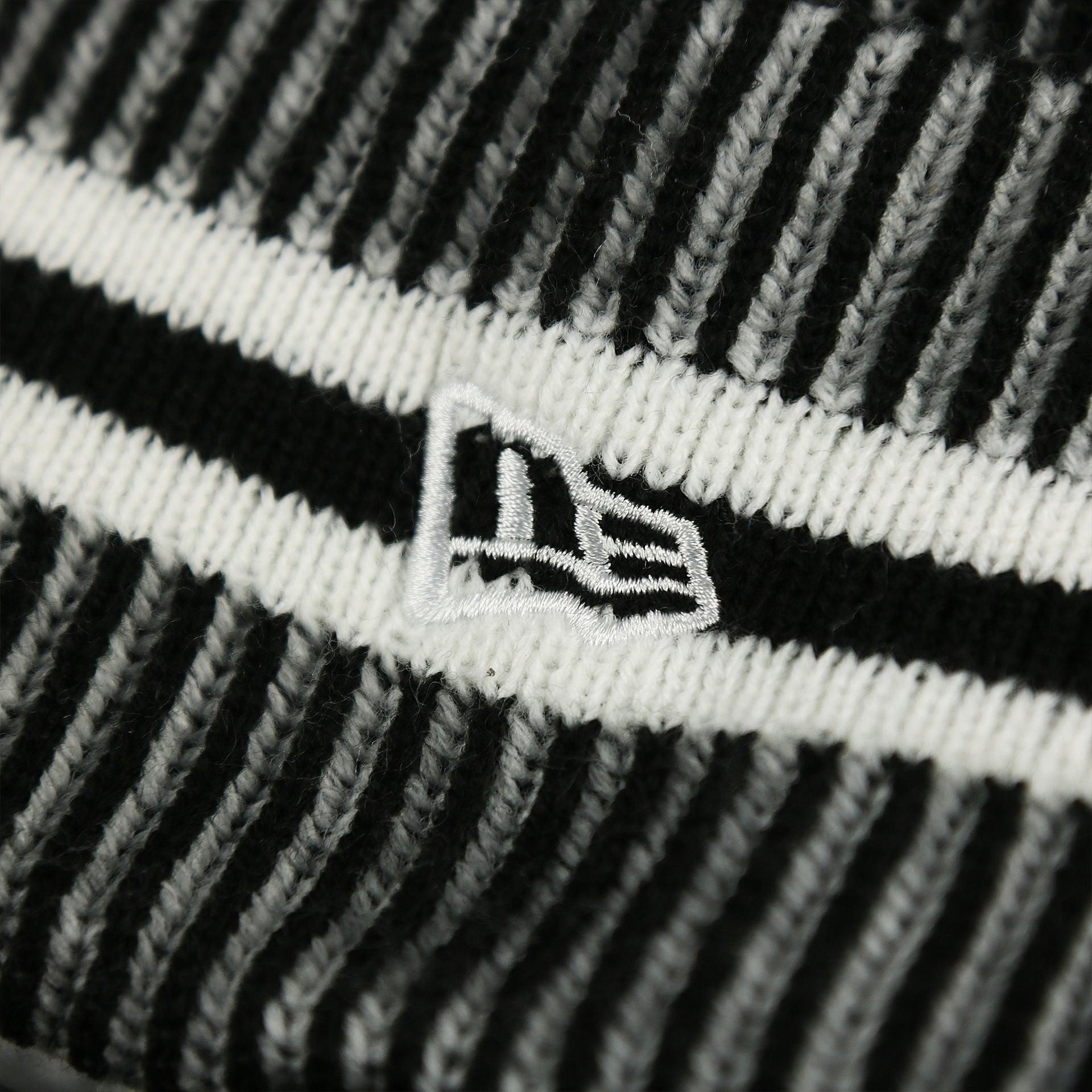 The New Era Logo on the Philadelphia Eagles On Field Cuffed Winter Pom Pom Beanie | Black And White Winter Beanie