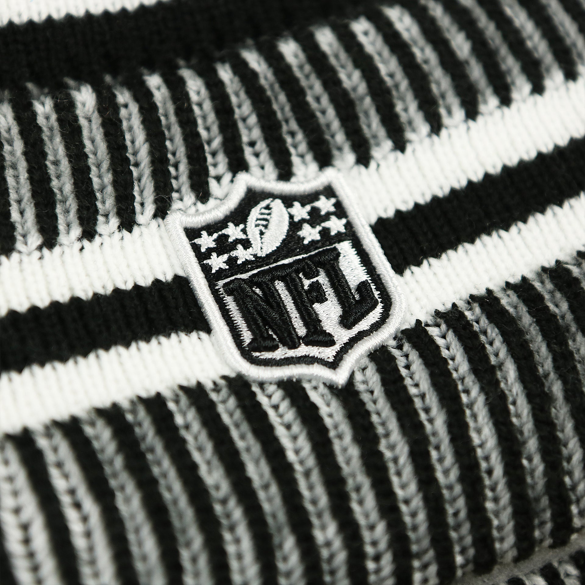 The NFL Logo on the Philadelphia Eagles On Field Cuffed Winter Pom Pom Beanie | Black And White Winter Beanie