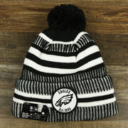 The front of the Philadelphia Eagles On Field Cuffed Winter Pom Pom Beanie | Black And White Winter Beanie