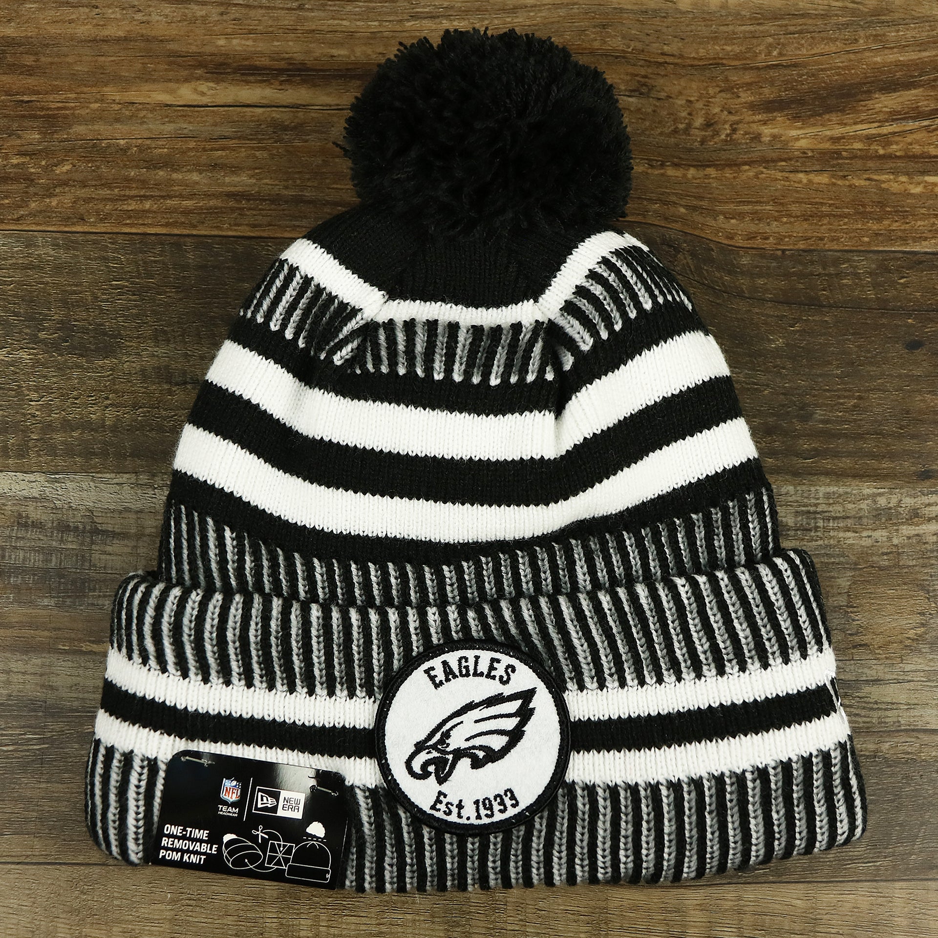 The front of the Philadelphia Eagles On Field Cuffed Winter Pom Pom Beanie | Black And White Winter Beanie