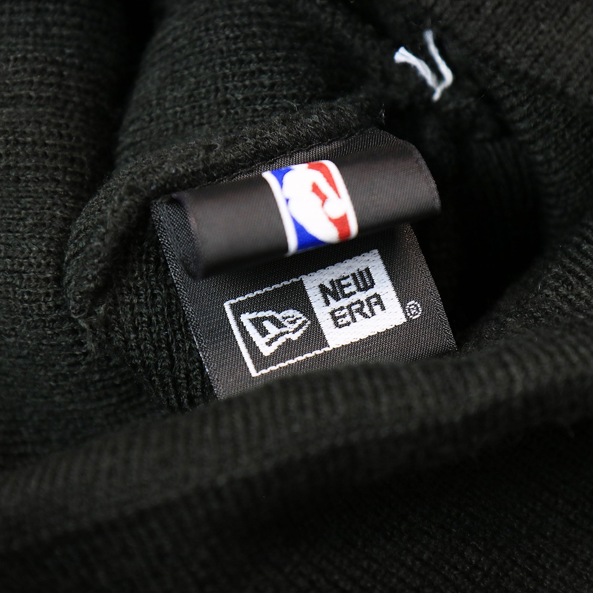 The New Era Tag on the Toronto Raptors NBA City Series Metallic Gold Leaf Winter Beanie | Black Winter Beanie
