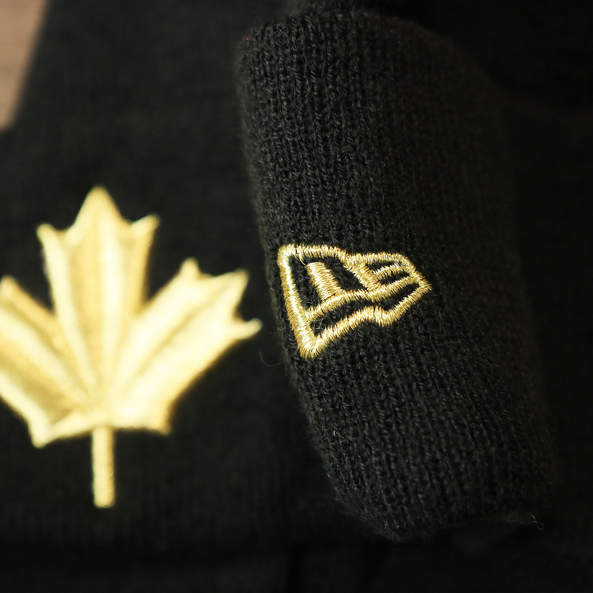 The New Era Logo on the Toronto Raptors NBA City Series Metallic Gold Leaf Winter Beanie | Black Winter Beanie