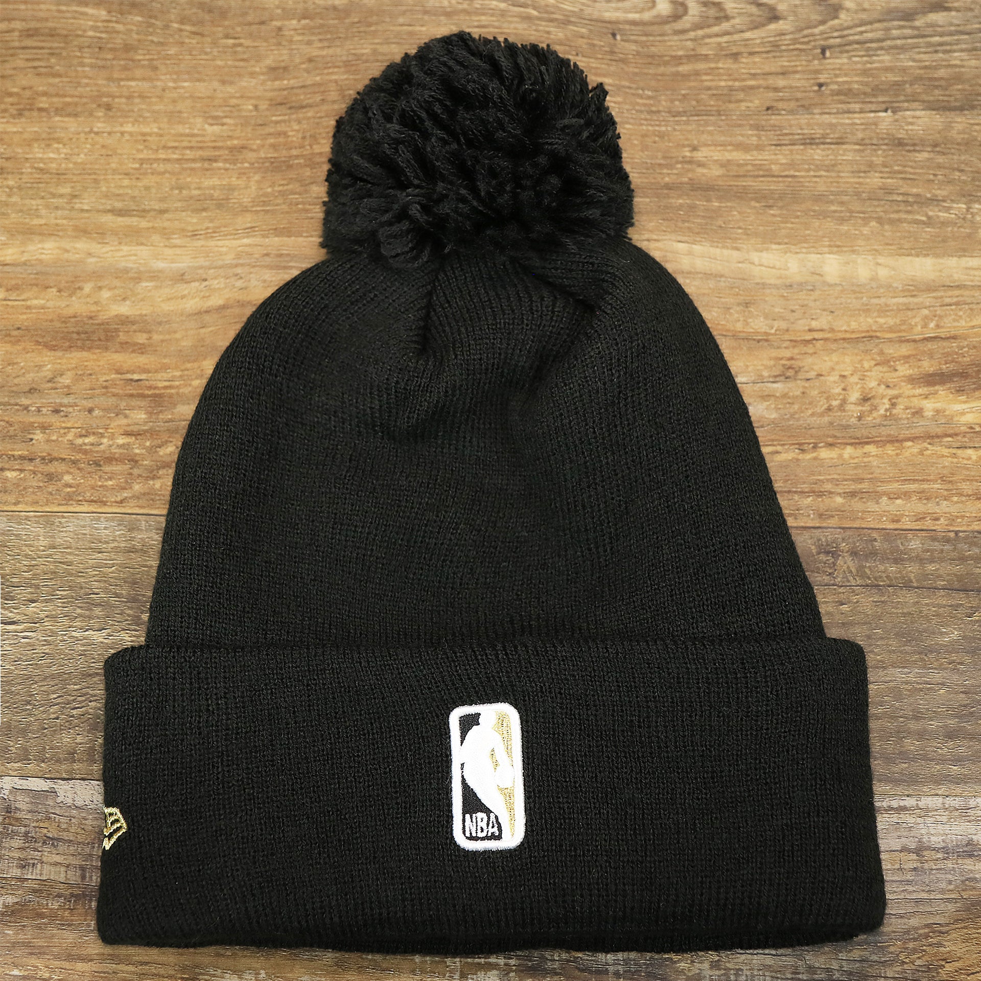 The backside of the Toronto Raptors NBA City Series Metallic Gold Leaf Winter Beanie | Black Winter Beanie