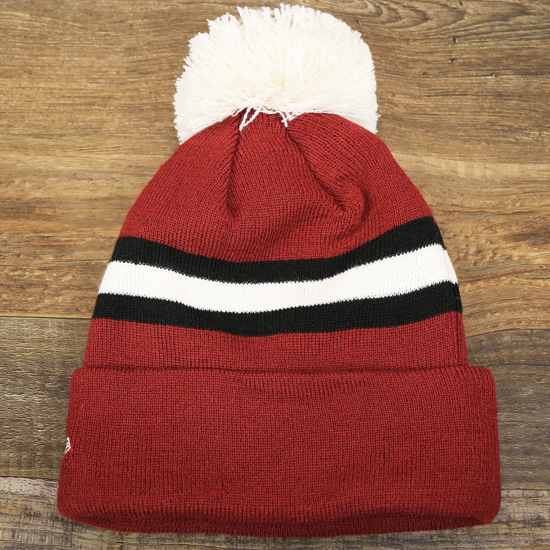 The backside of the Throwback Philadelphia Eagles White Logo Striped Cuffed Winter Beanie | Maroon Winter Beanie