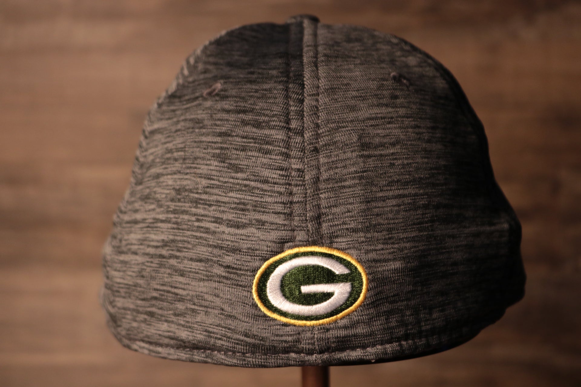 The backside of this packers cap has the packers logo Packers 2020 Training Camp Flexfit | Green Bay Packers 2020 On-Field Grey Training Camp Stretch Fit