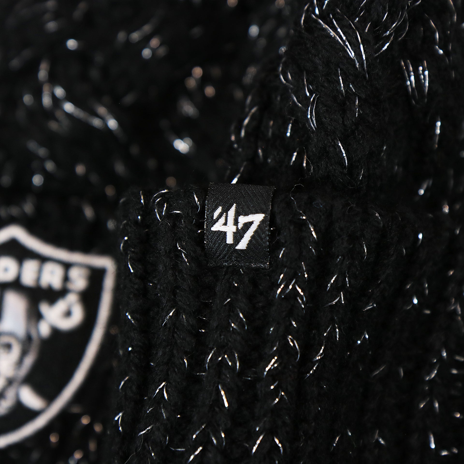 The 47 Brand Tag on the Women’s Las Vegas Raiders Reflective Silver Cuffed Pom Pom Winter Beanie | Black Winter Beanie
