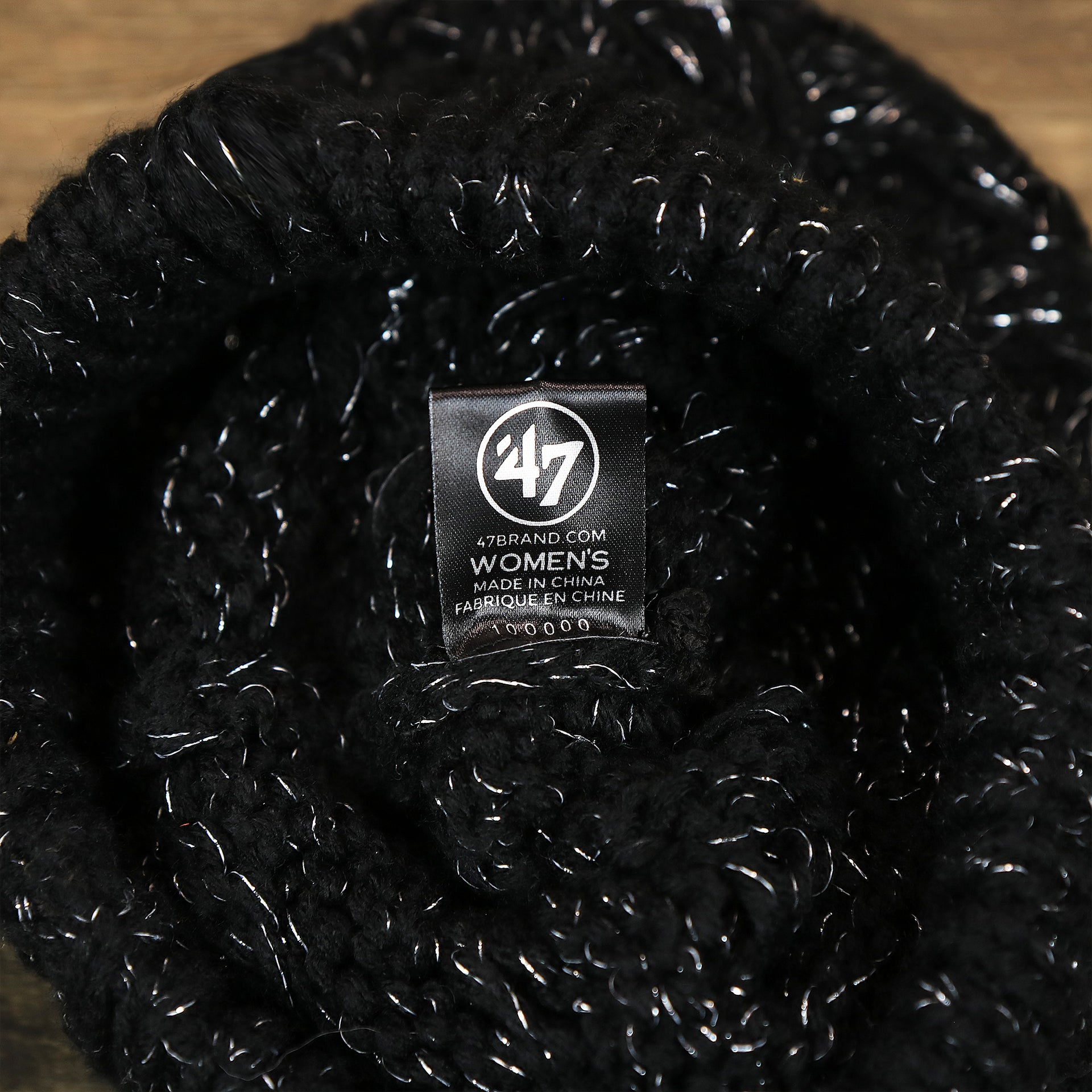 The 47 Brand Tag on the Women’s Las Vegas Raiders Reflective Silver Cuffed Pom Pom Winter Beanie | Black Winter Beanie
