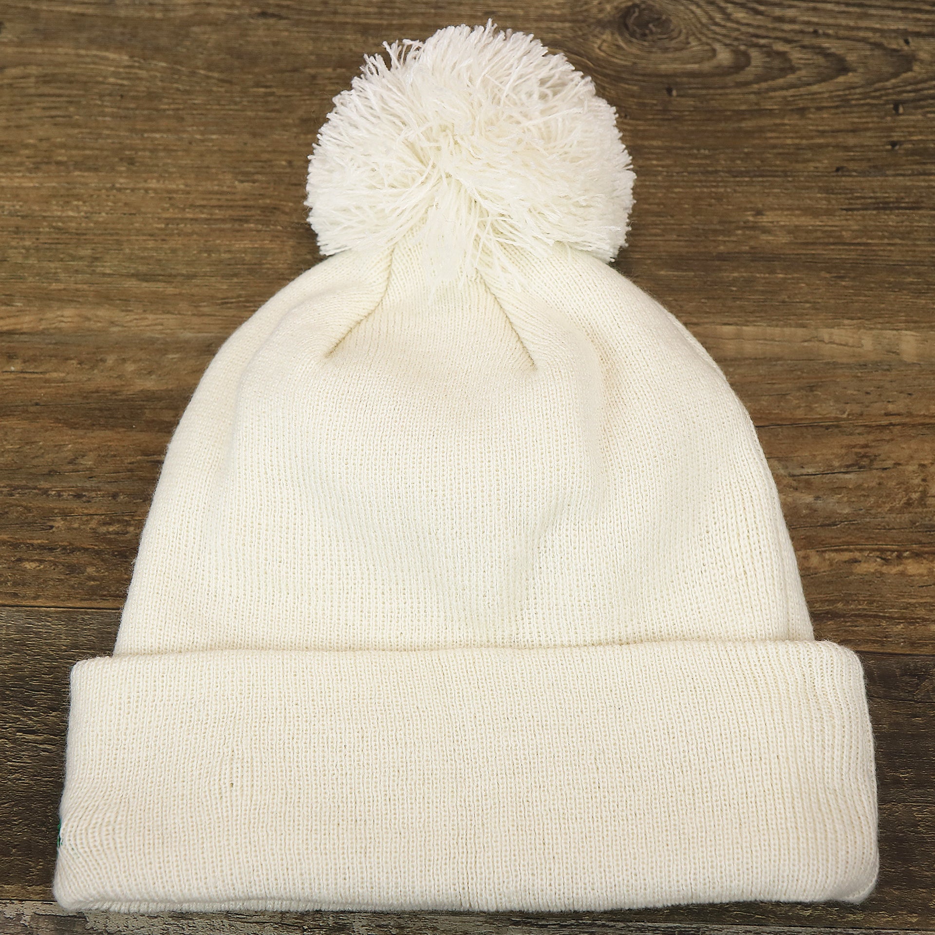 The backside of the Philadelphia Eagles Script Cuffed Winter Beanie With Pom Pom | Ivory Winter Beanie