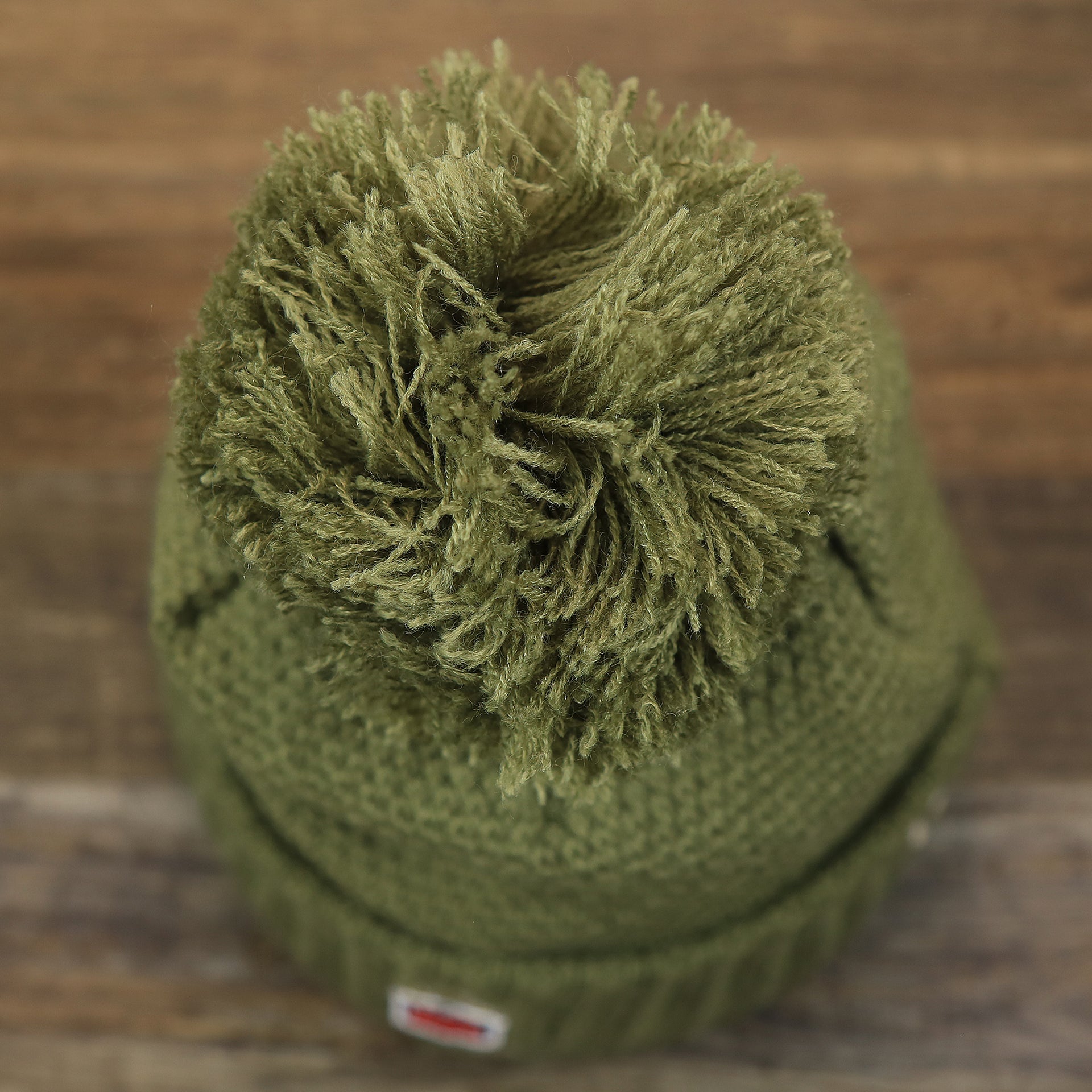 The Military Green Pom Pom on the Women’s Philadelphia Eagles Salute To Service Ribbon Rubber Military Eagles Patch On Field NFL Beanie | Women’s Military Green Beanie