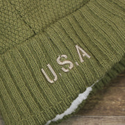 The USA Wordmark on the Women’s Philadelphia Eagles Salute To Service Ribbon Rubber Military Eagles Patch On Field NFL Beanie | Women’s Military Green Beanie