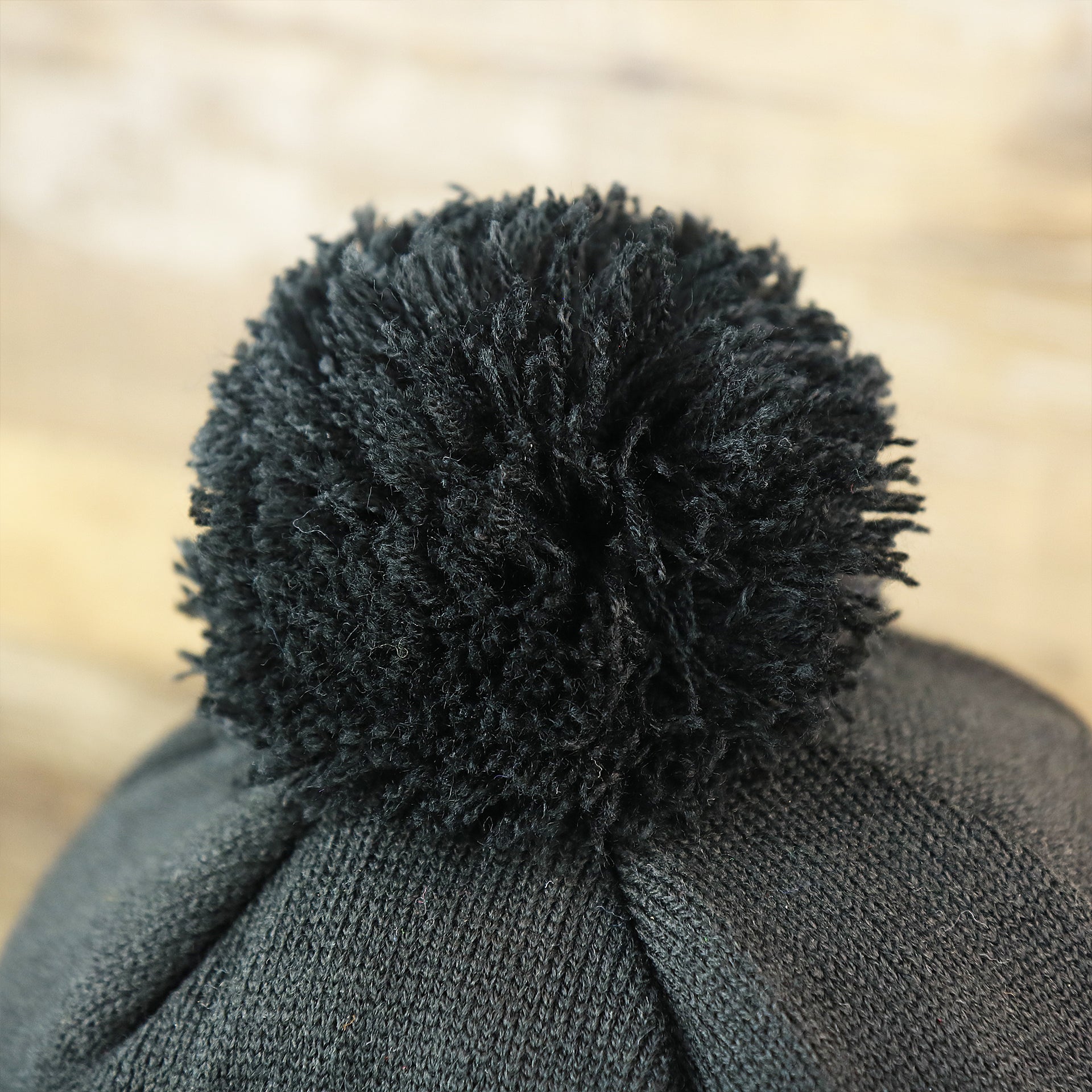 The Black Pom Pom on the Philadelphia Eagles On Field Cuffed Winter Pom Pom Beanie | Black And White Winter Beanie