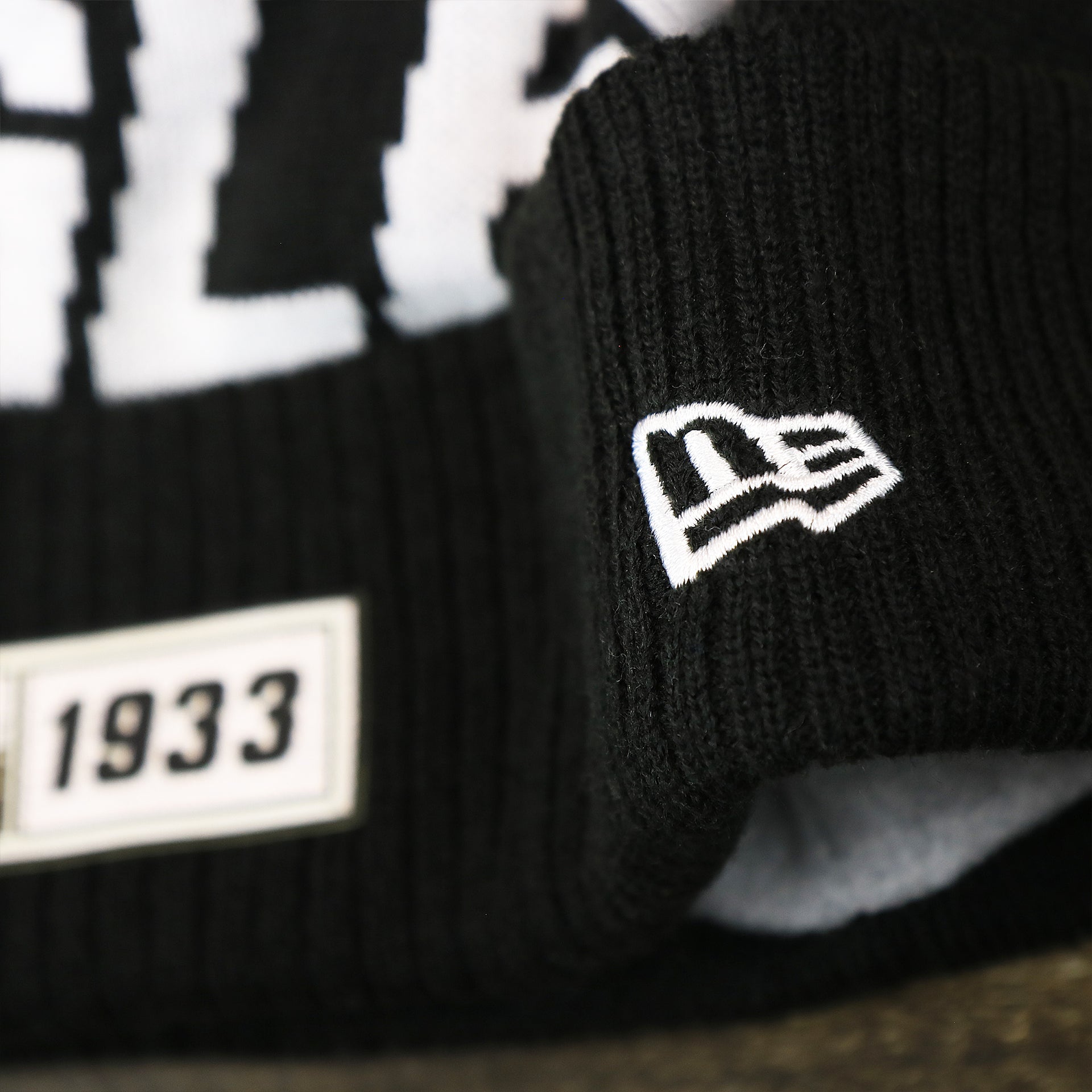 The New Era Logo on the Philadelphia Eagles On Field Cuffed Winter Pom Pom Beanie | Black And White Winter Beanie