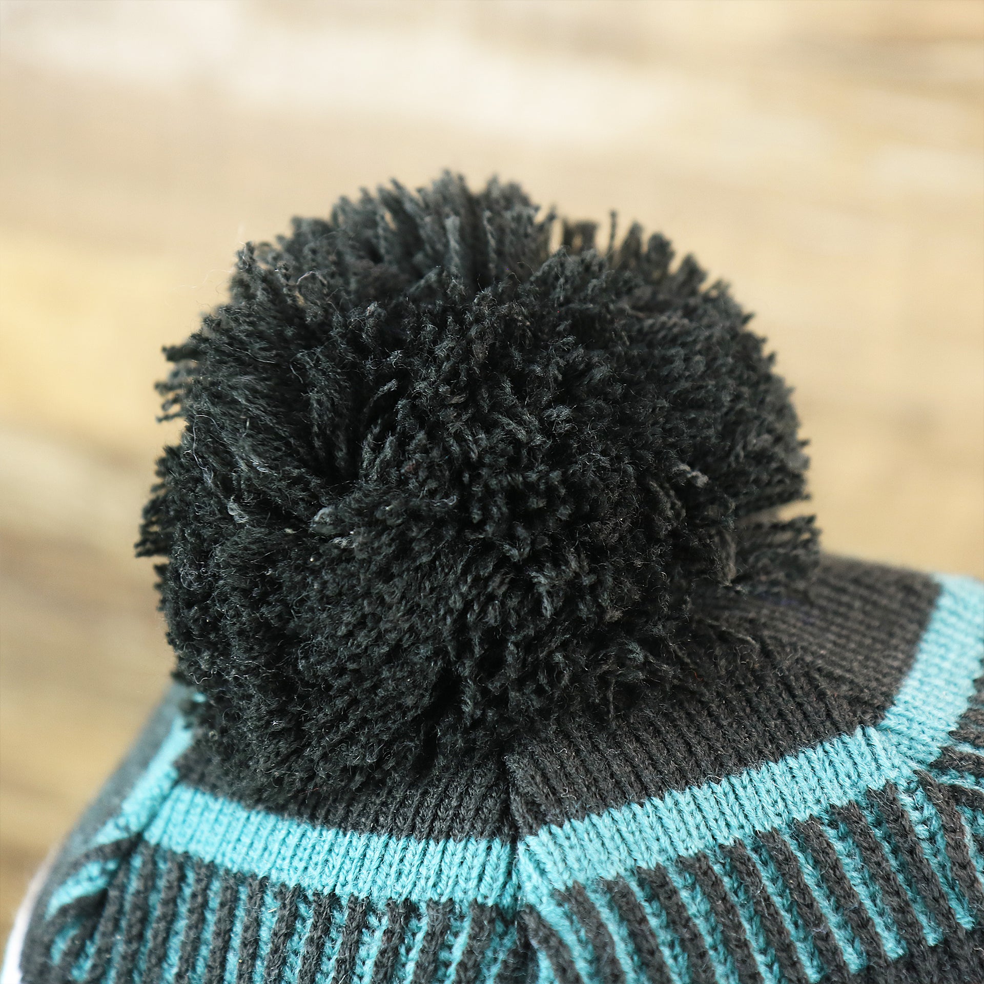 The Black Pom Pom on the Philadelphia Eagles Patch 1933 On Field Striped Eagles Colorway Pom Pom Winter Beanie | Black and Midnight Green Winter Beanie