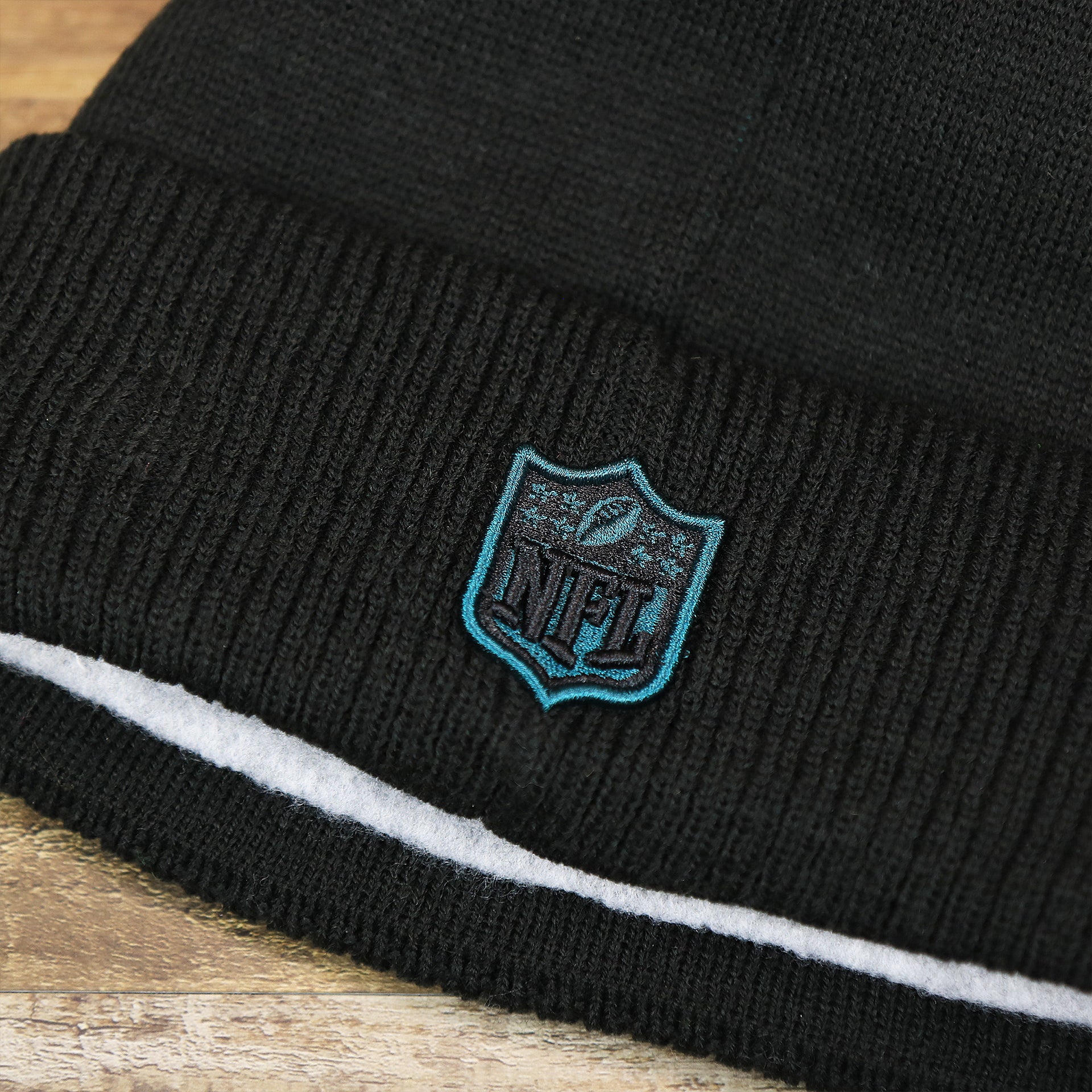 The NFL Logo on the Philadelphia Eagles On Field Since 1933 Eagles Patch Winter Pom Pom Beanie | Black Winter Beanie