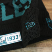 The New Era Logo on the Philadelphia Eagles On Field Since 1933 Eagles Patch Winter Pom Pom Beanie | Black Winter Beanie