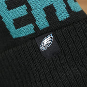 The Eagles Tag on the Philadelphia Eagles On Field Since 1933 Eagles Patch Winter Pom Pom Beanie | Black Winter Beanie