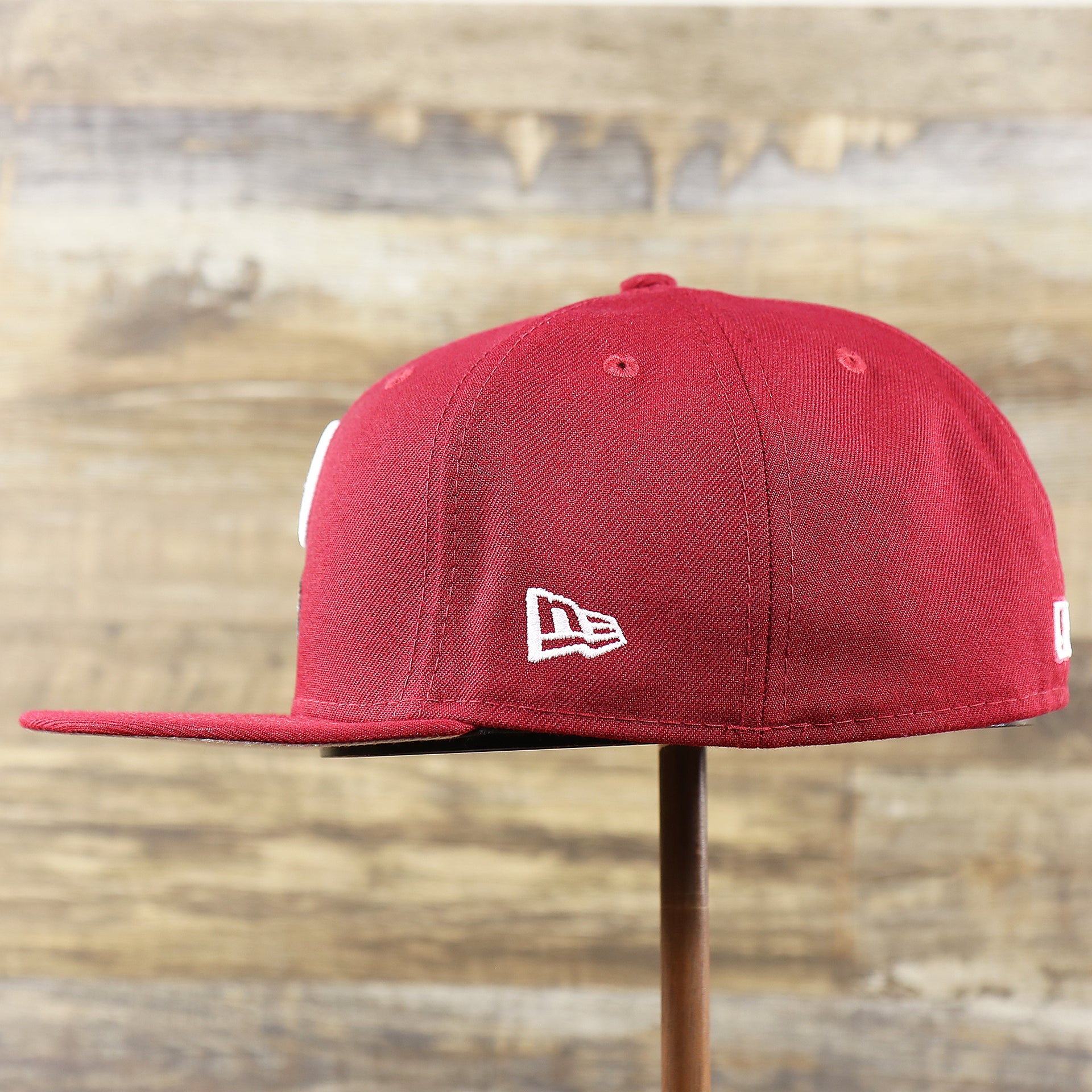 The wearer's left of the Cooperstown Philadelphia Phillies Baseball Heart Gray Bottom World Series 59Fifty Fitted Cap | Maroon 59Fifty Cap