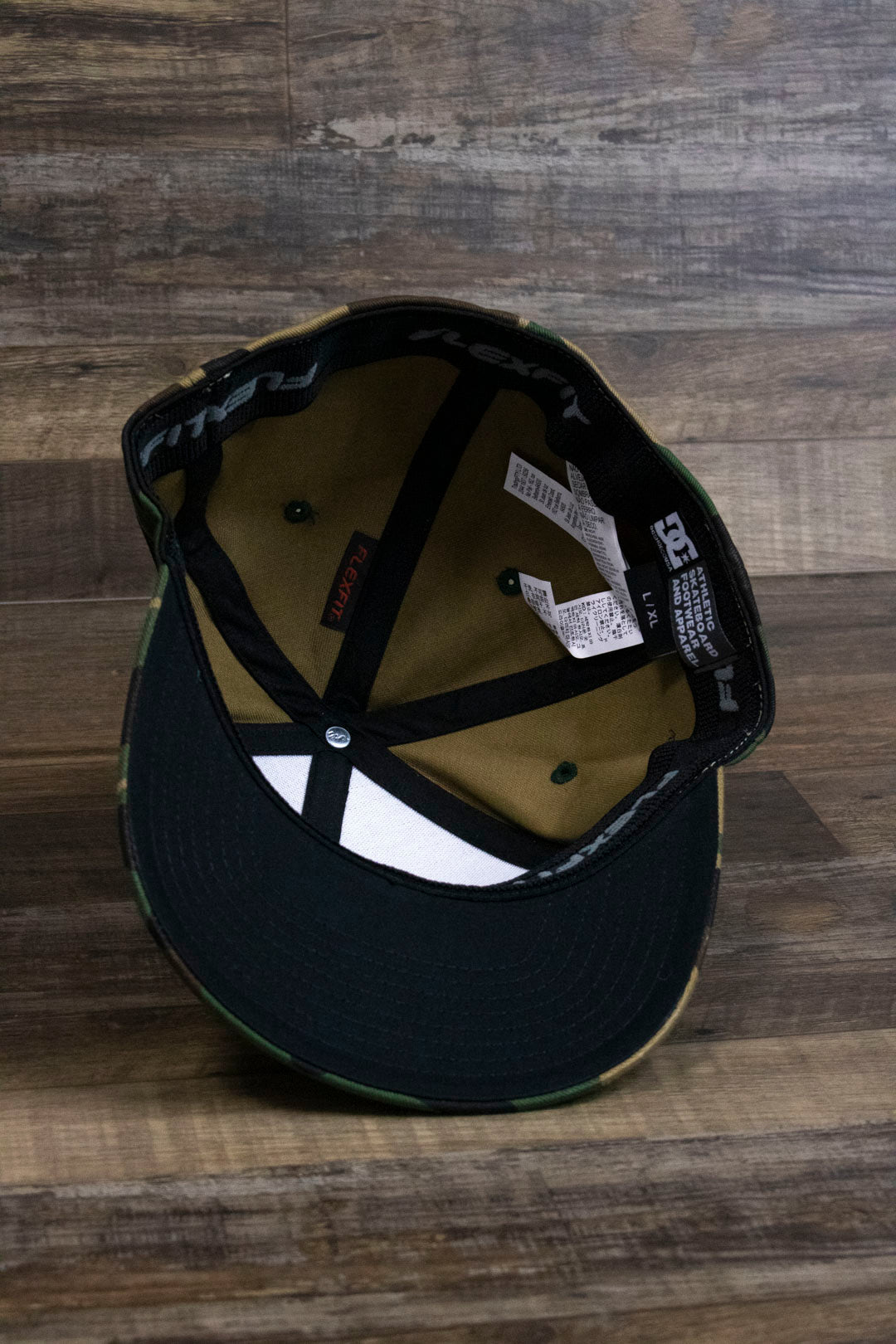 the Camouflage Print Skater Hat | DC Shoes Black Bottom Camo Flexfit Cap has a black underbrim