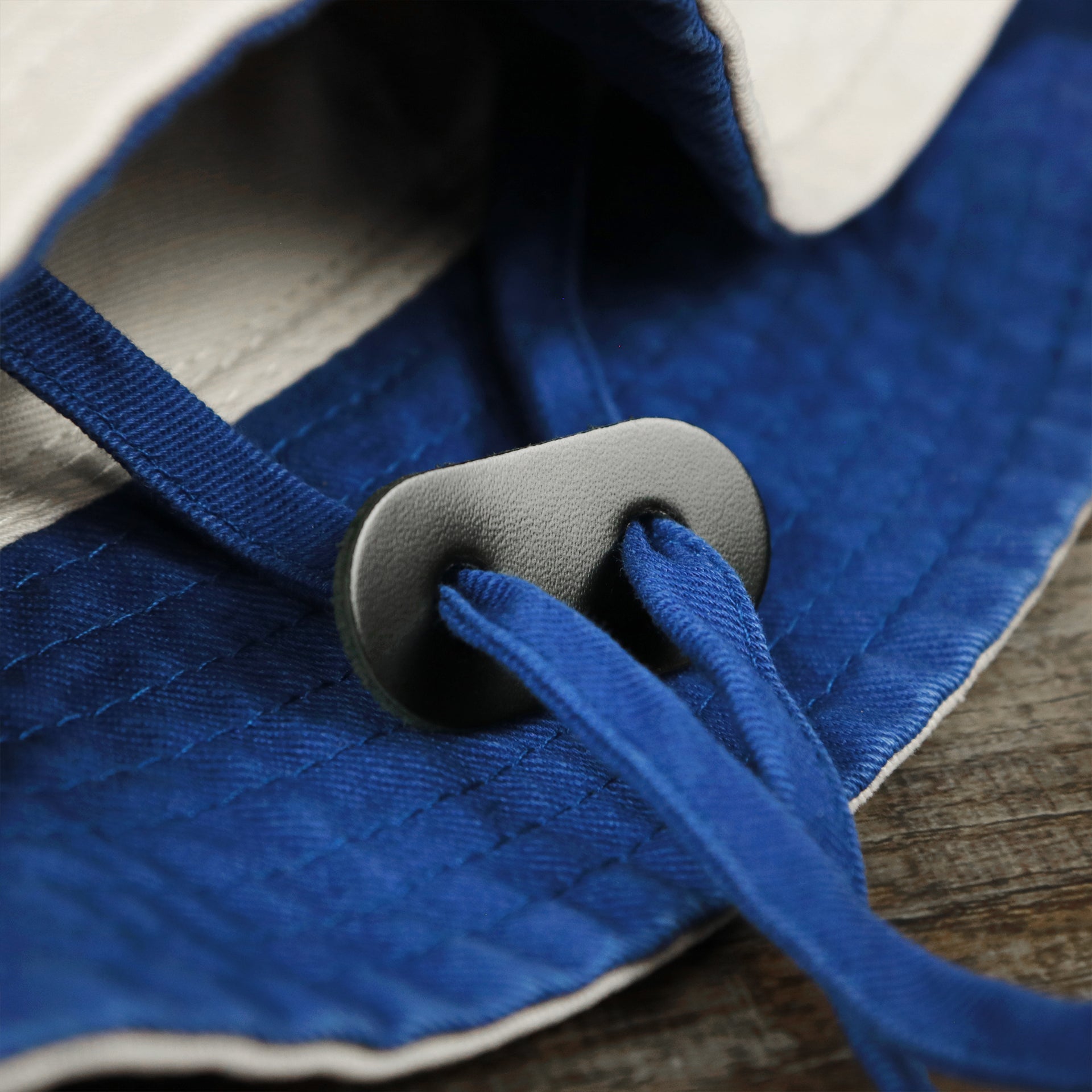 The Chin Strap on the Philadelphia 76ers Logo Royal Blue Undervisor Bucket Hat | Natural Bucket Hat