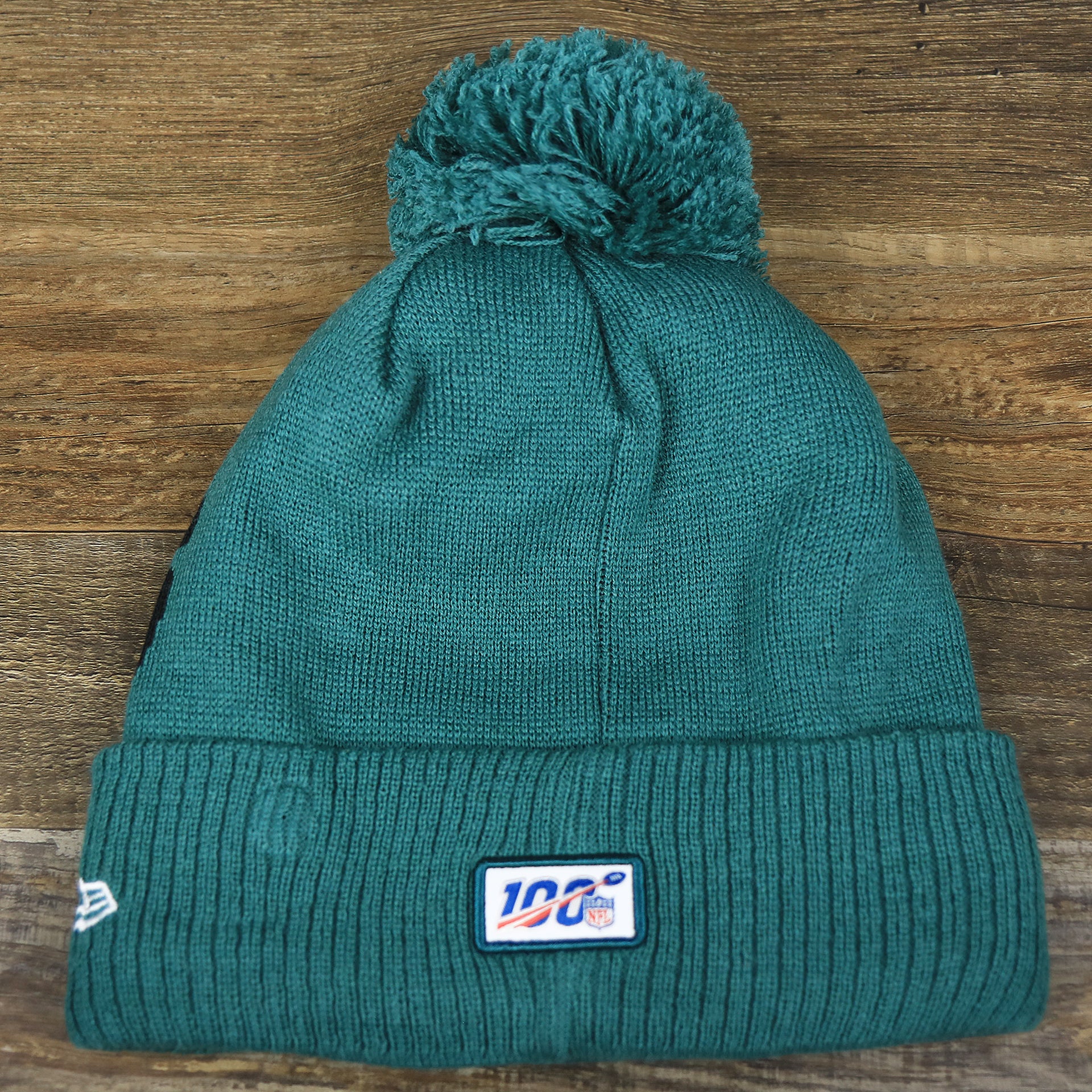 The backside of the Philadelphia Eagles On Field Since 1933 Eagles Patch Winter Pom Pom Beanie | Midnight Green Winter Beanie