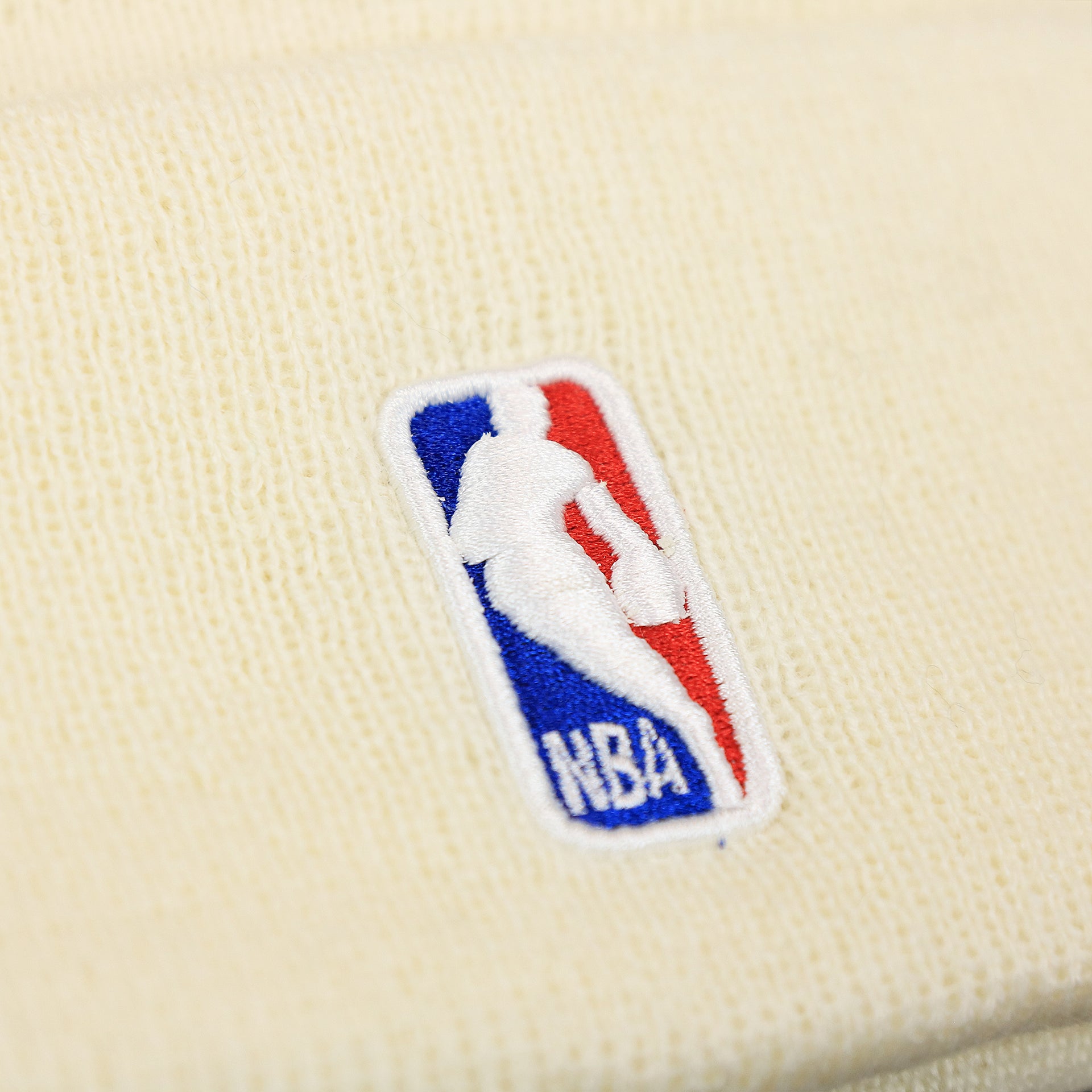 The NBA Jerry West Logo on the Philadelphia 76ers NBA City Series Cracker Liberty Bell Winter Beanie | Cream Winter Beanie