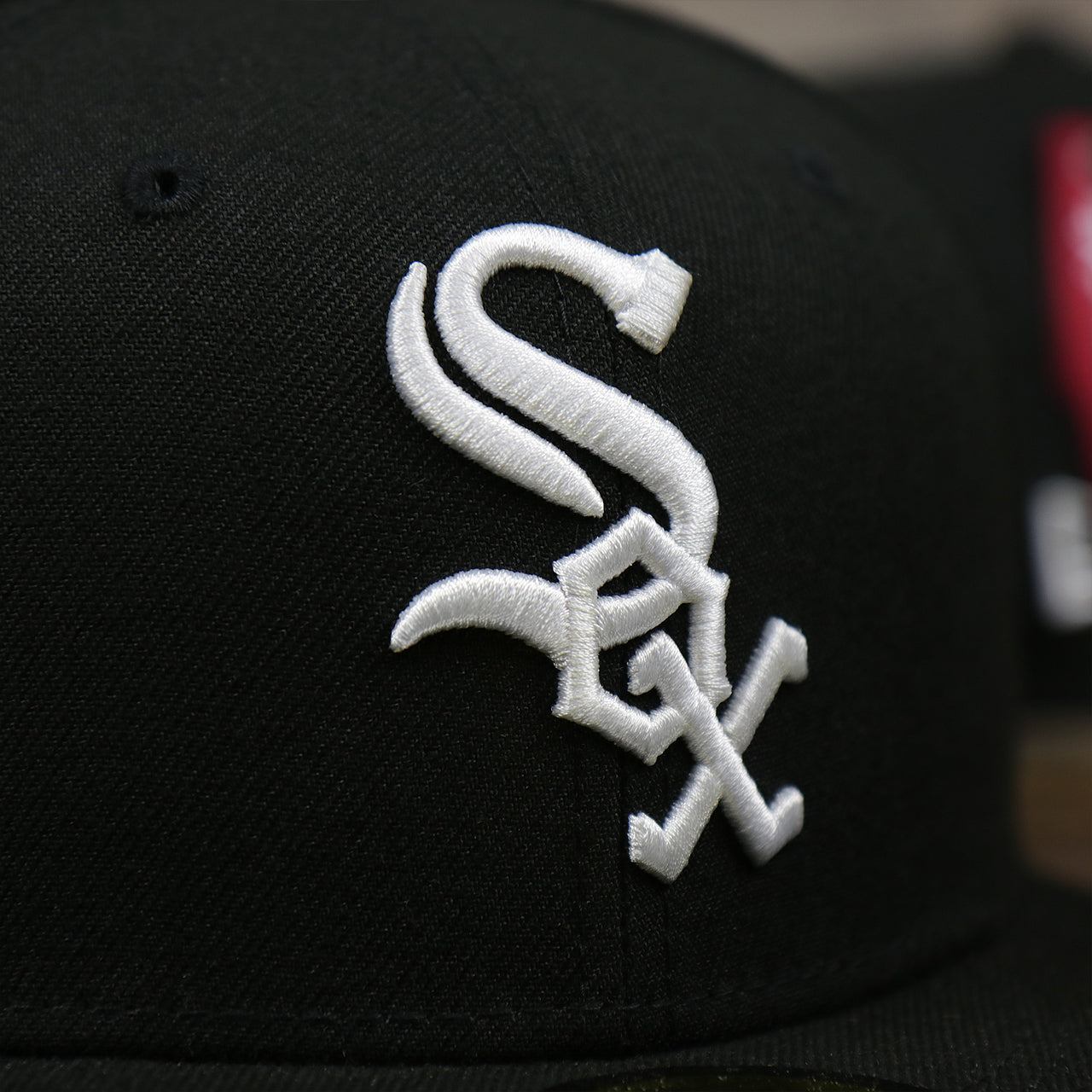 The White Sox Logo on the Chicago White Sox Alpha Industries Side Patch Army Green Undervisor 59FIfty Fitted Cap With Hangtag | Black 59FIfty Cap