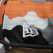 The New Era logo on the Throwback Tampa Bay Buccaneers OnField NFL Summer Training 2022 39Thirty Camo FlexFit Cap | New Era Orange