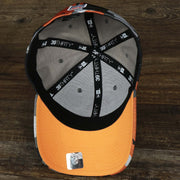 The underside of the Throwback Tampa Bay Buccaneers OnField NFL Summer Training 2022 39Thirty Camo FlexFit Cap | New Era Orange