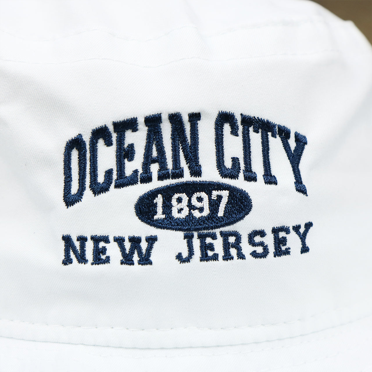 The OCNJ Wordmark on the Ocean City New Jersey Wordmark Since 1897 Bucket Hat | White Bucket Hat
