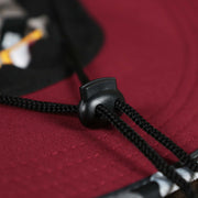 The Adjustable Chin Strap on the Washington Commanders NFL Summer Training Camp 2022 Camo Bucket Hat | Burgundy Bucket Hat
