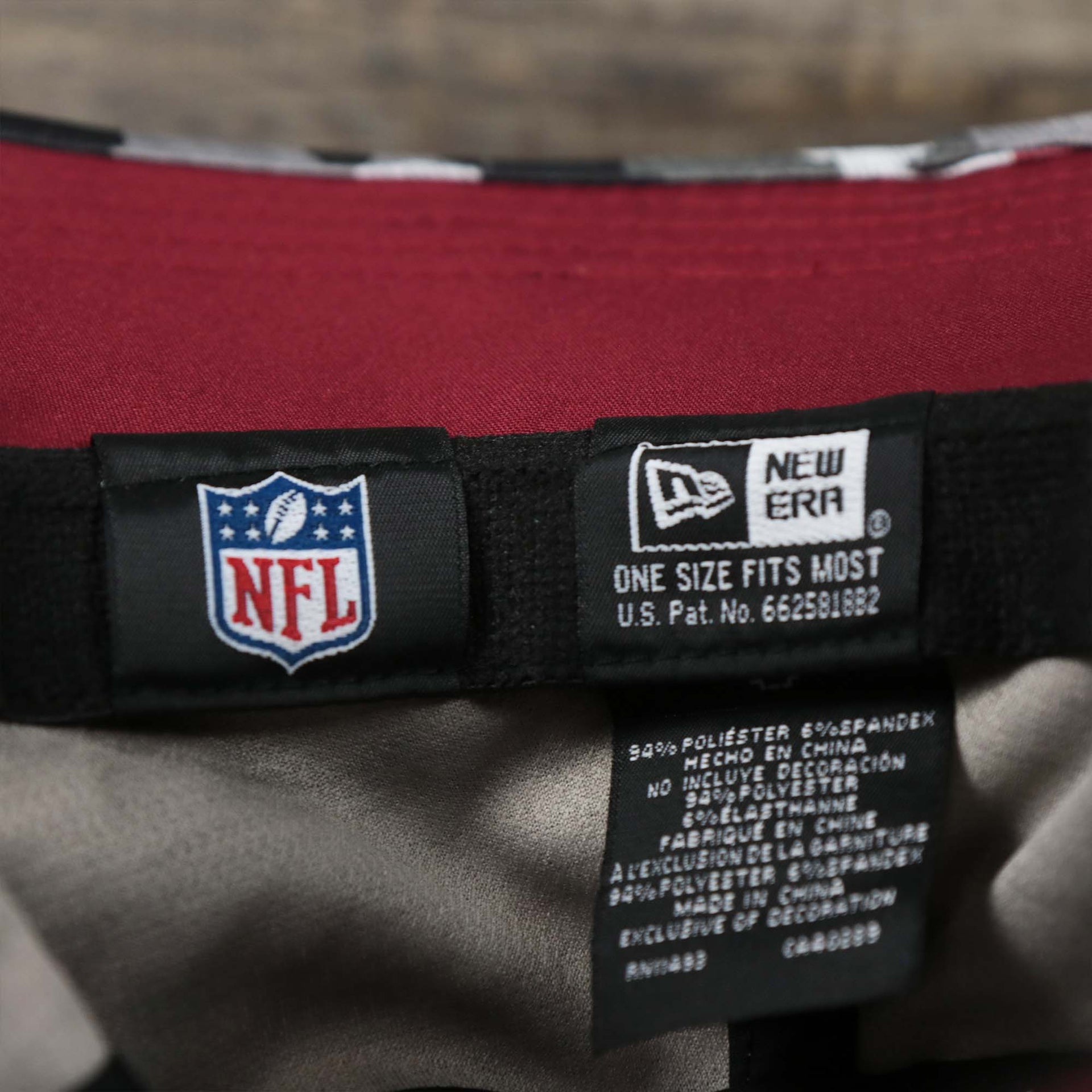 The NFL Tags and New Era Tags on the Washington Commanders NFL Summer Training Camp 2022 Camo Bucket Hat | Burgundy Bucket Hat