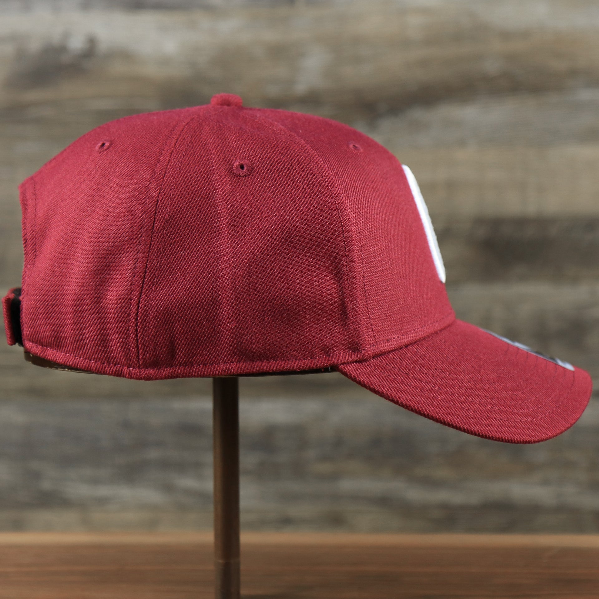 The wearer's right on the Cooperstown Philadelphia Phillies Retro Phillies Logo Gray Bottom Dad Hat | Maroon Dad Hat