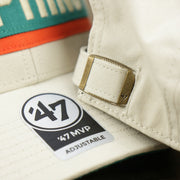 The 47 Brand Sticker on the Throwback Miami Dolphins Striped Wordmark Legacy Dolphins Side Patch Crossroad Dad Hat | Bone Dad Hat