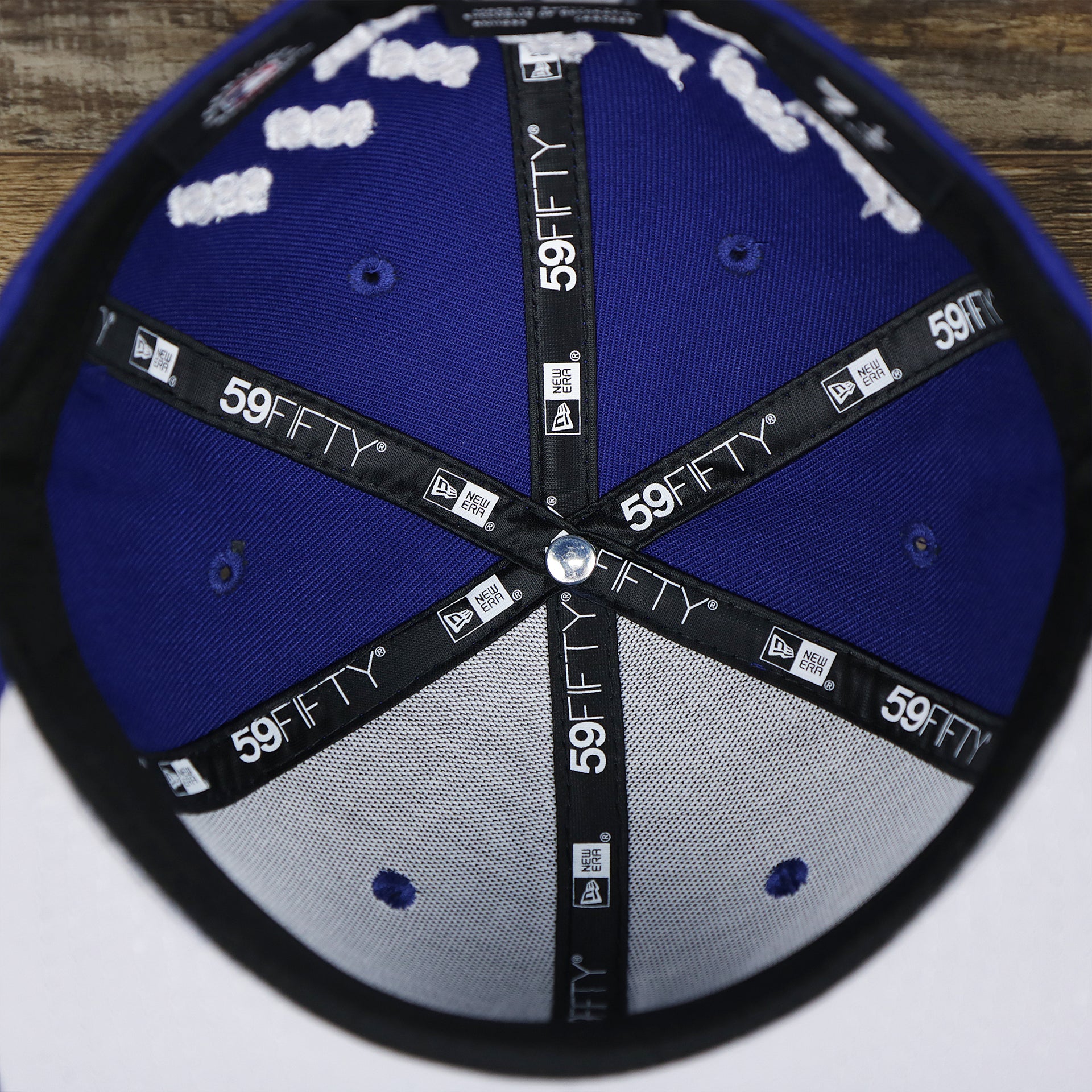 The inside of the Los Angeles Dodgers Crown Champions Gray Bottom World Championship Wins Embroidered Fitted Cap | Royal Blue 59Fifty Cap
