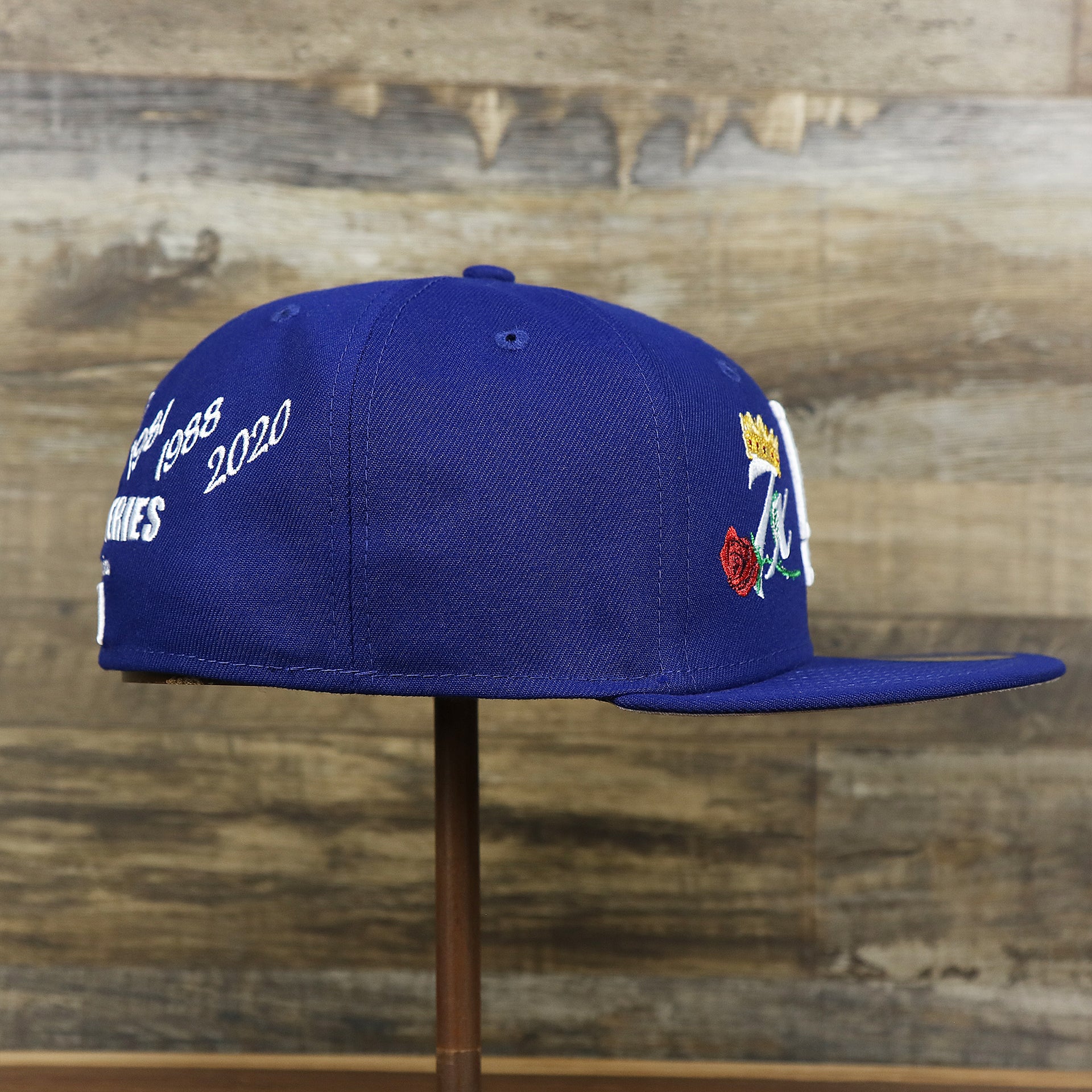 The wearer's right on the Los Angeles Dodgers Crown Champions Gray Bottom World Championship Wins Embroidered Fitted Cap | Royal Blue 59Fifty Cap