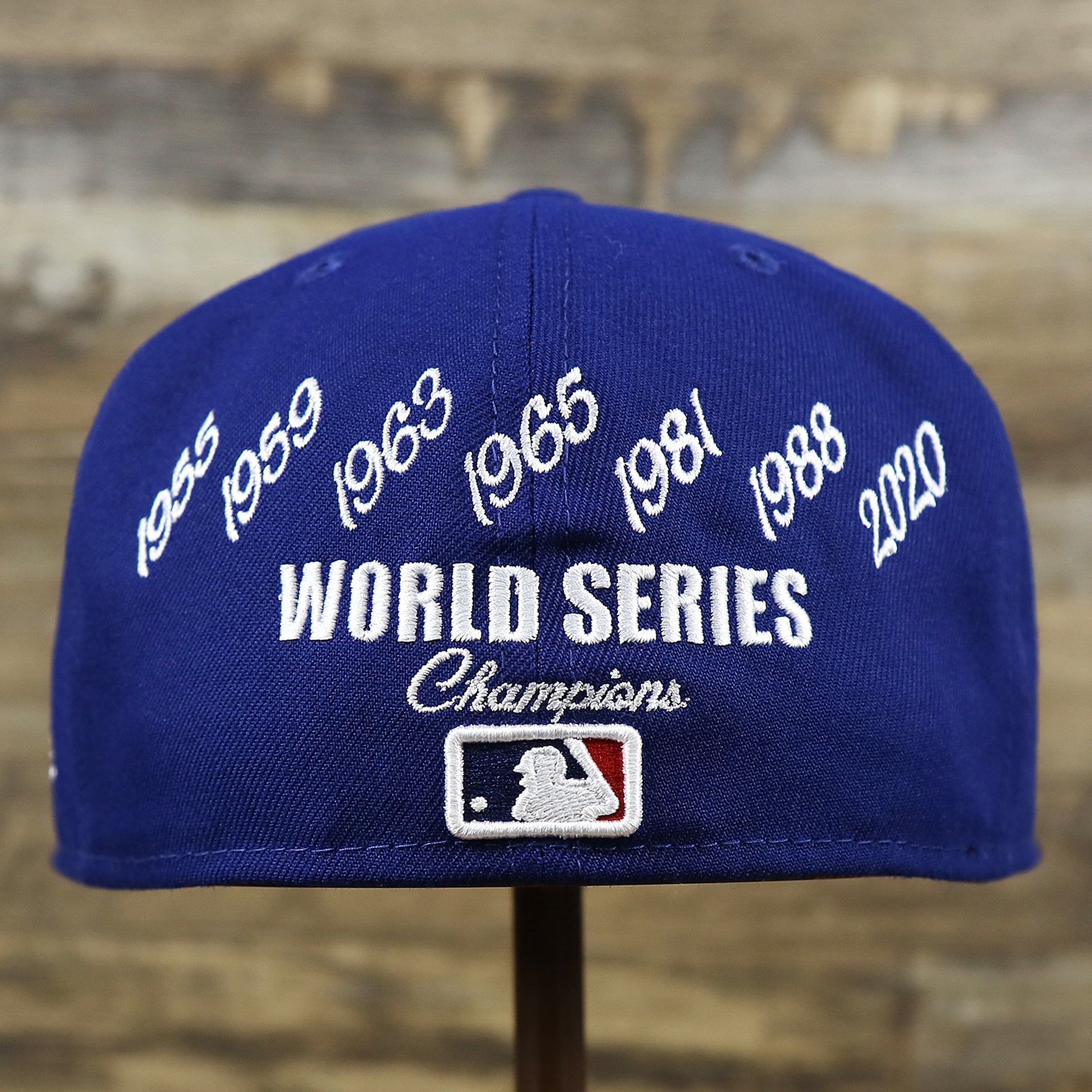 The backside of the Los Angeles Dodgers Crown Champions Gray Bottom World Championship Wins Embroidered Fitted Cap | Royal Blue 59Fifty Cap