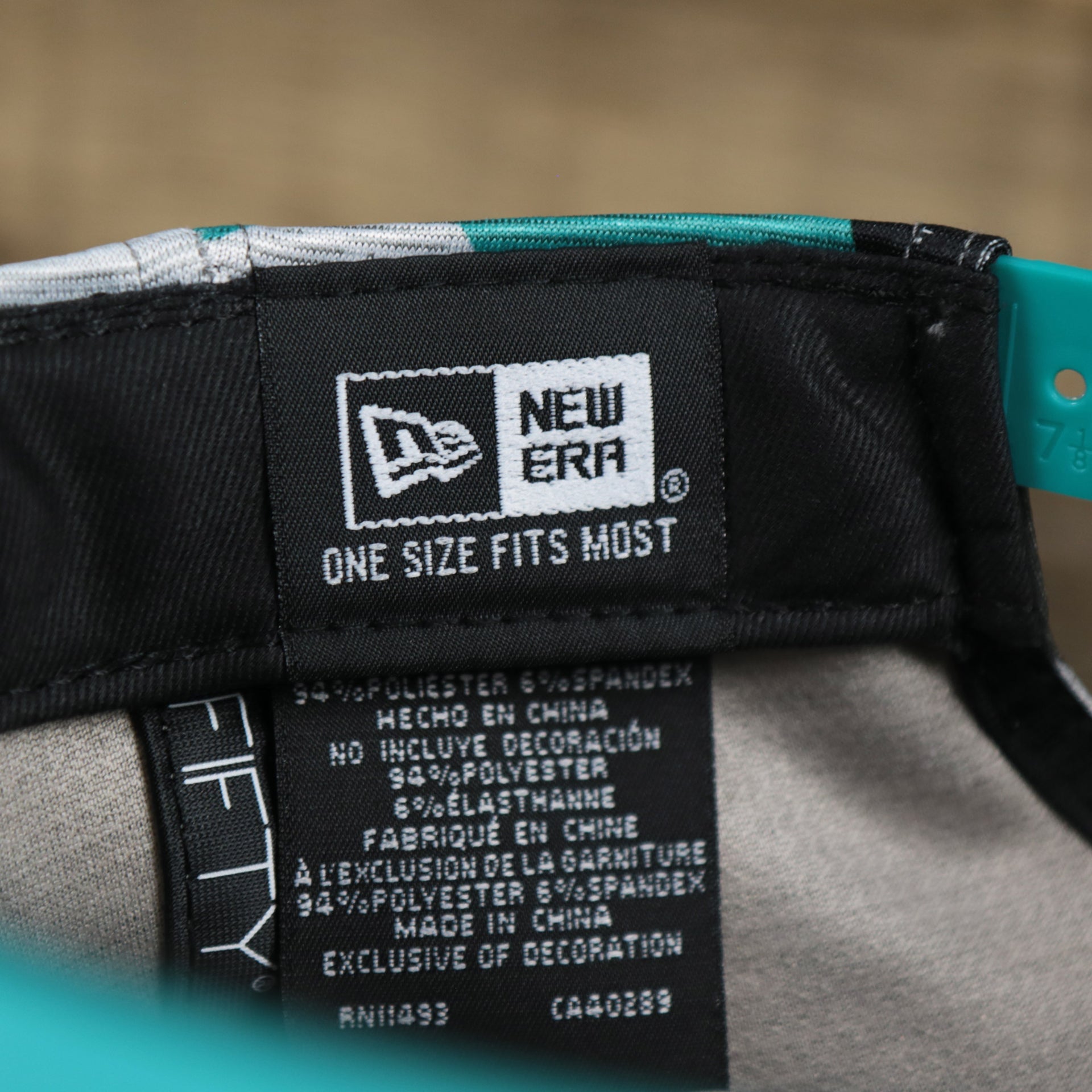 The New Era Tag on the Miami Dolphins NFL OnField Summer Training 2022 Camo 9Fifty Snapback | Turquoise Camo 9Fifty