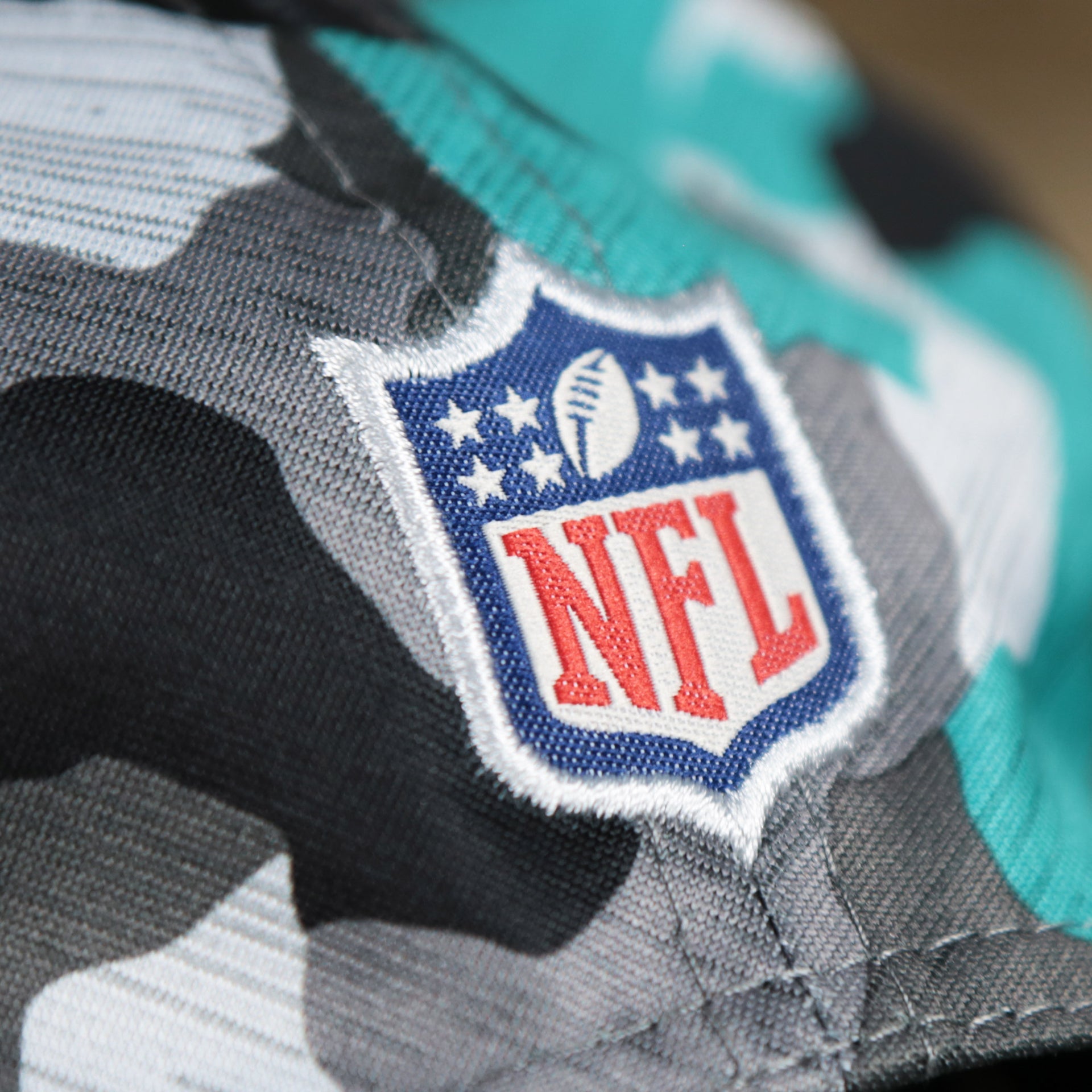 The NFL Logo on the back of the Miami Dolphins NFL OnField Summer Training 2022 Camo 9Fifty Snapback | Turquoise Camo 9Fifty